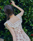Back view of Lacemade "Red Garnet" dress - romantic lace ruffle sleeves and bow tie detail