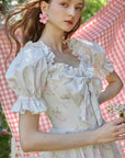 "Bloom in Coral Island" dress - Detailed view of puff sleeves and floral cotton fabric