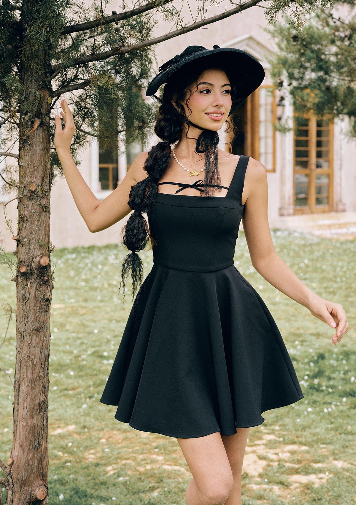Front view of "Beyond Campus" black sleeveless A-line mini dress