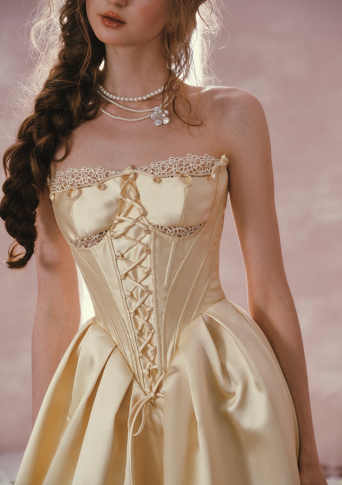 Detailed view of the structured satin and lace-trimmed neckline on Belle's Gilded