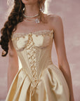 Detailed view of the structured satin and lace-trimmed neckline on Belle's Gilded