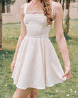 Detailed view of structured woven fabric on Beyond Campus white mini dress