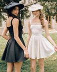Back view of "Beyond Campus" black mini dress featuring a concealed zipper