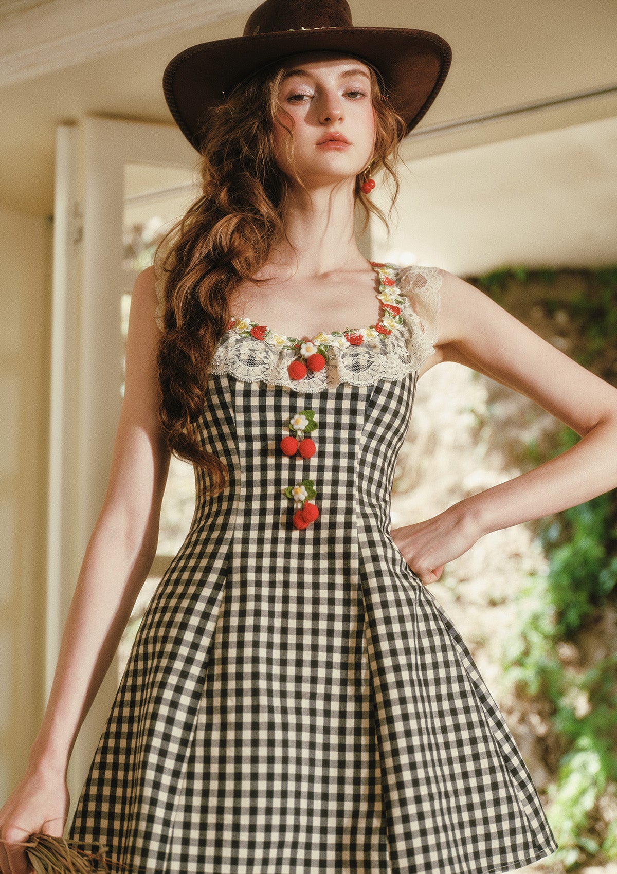 Close-up of strawberry embroidery and lace trim on Lacemade gingham dress