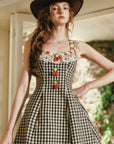 Close-up of strawberry embroidery and lace trim on Lacemade gingham dress