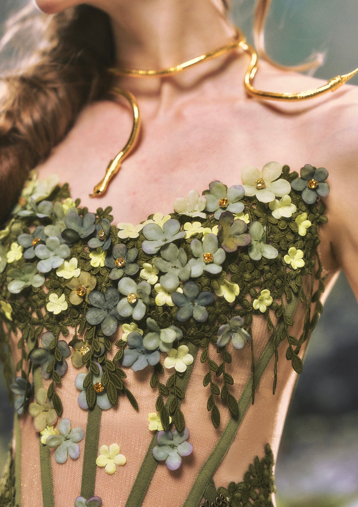 "Eucalyptus Fairy" green corset - Close-up of 3D floral appliqués and rhinestone details
